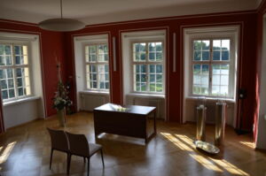 Das Foto zeigt das Trauzimmer im Palais Zabeltitz. Zu sehen sind zwei leere Stühle, auf denen das Brautpaar Platz nehmen kann, und der Schreibtisch des Standesbeamten.